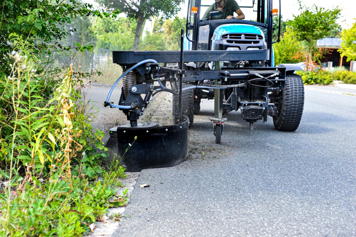 Einsatzbild von einer Wildkrautbürste. Ein Anbaugerät für die Kommunaltechnik. Klein- und Kompakttraktoren.